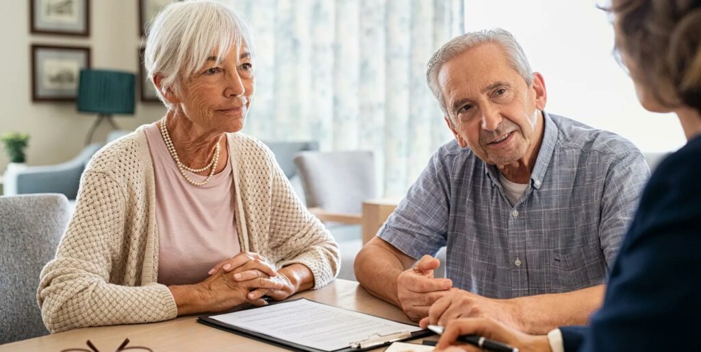 Senior couple reviewing Medicare coverage options with a local independent insurance agent at home in Richland, Michigan.