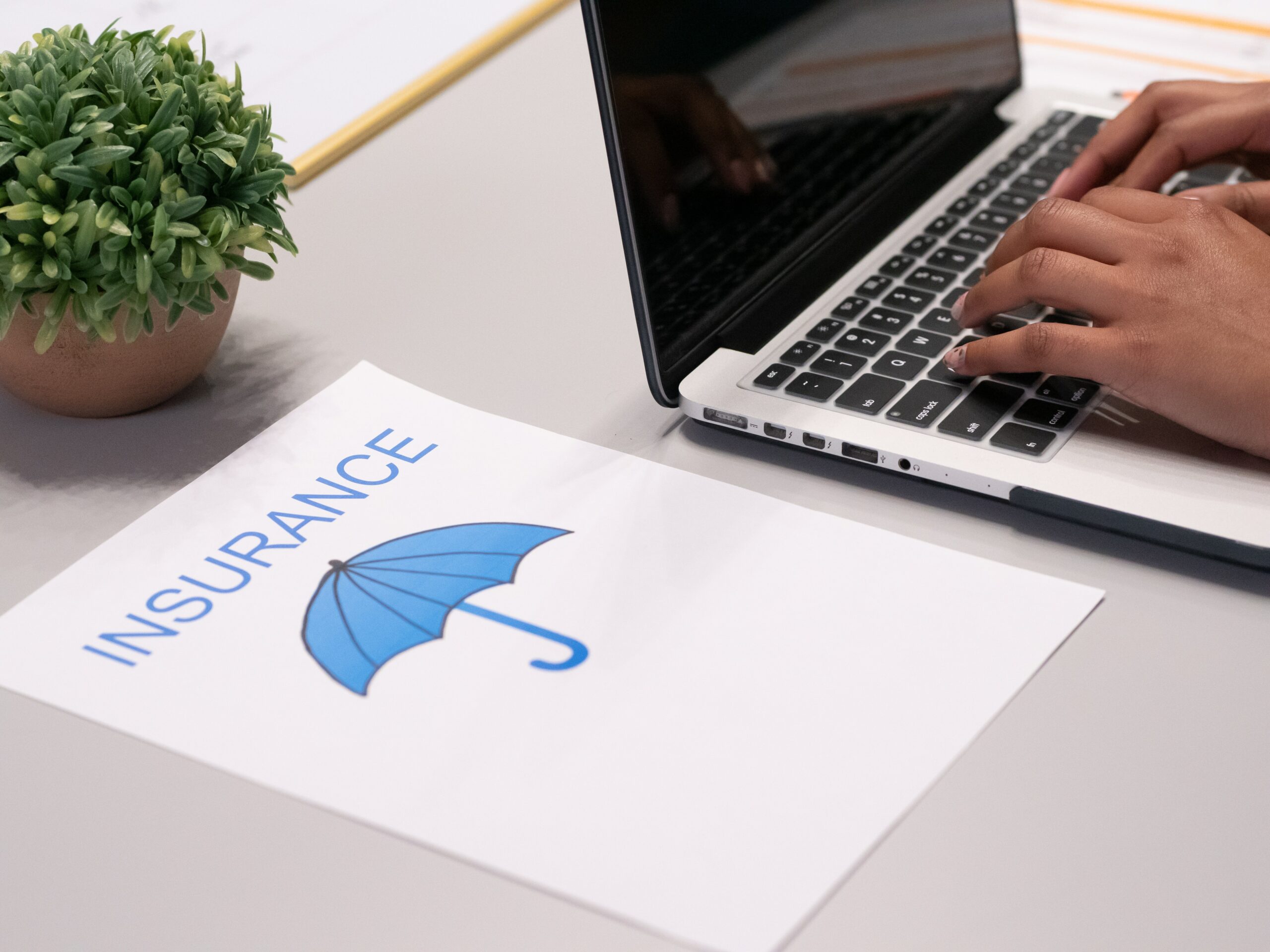 Senior reviewing Medicare supplement insurance information on a laptop at home